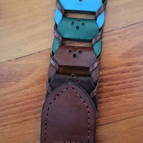 Colorful woven belt in warm shades made of faux leather, like new