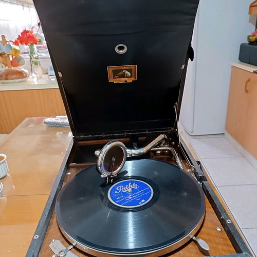 His Master's Voice portable gramophone used with accessories