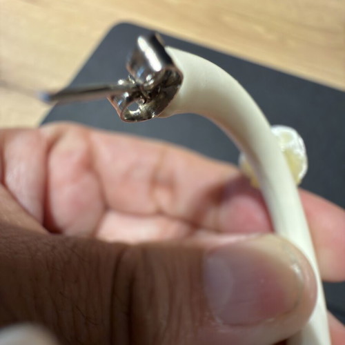 Pair of off-white matte resin hoop earrings with fabric floral accents