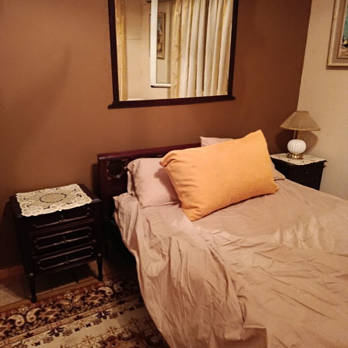Double bed with two nightstands, mirror and unused mattress