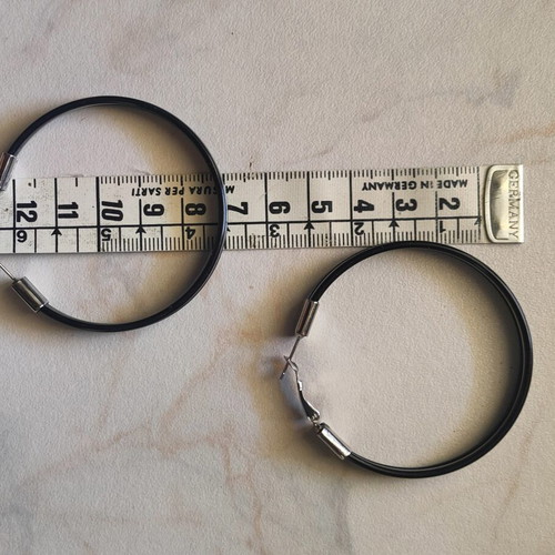 Large black hoop earrings used with silver details