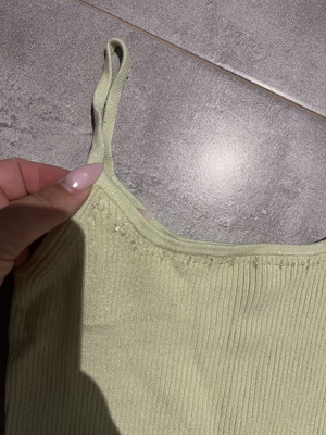 Ribbed green top with thin straps and subtle rhinestones