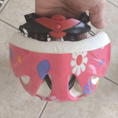 Pink bicycle helmet with flower and heart design