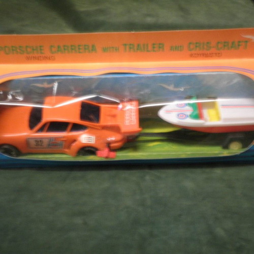 Winding Porsche Carrera car with Cris-Craft and trailer new