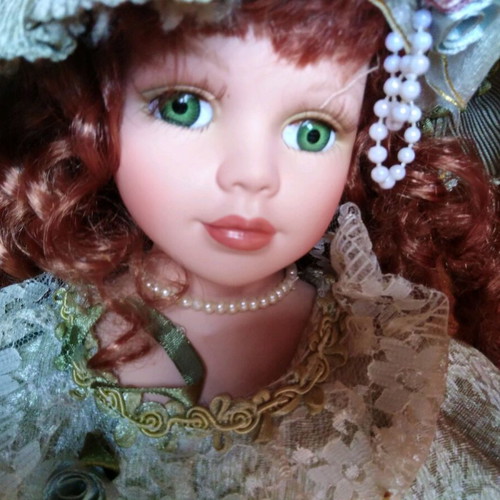 Porcelain doll with green eyes like new
