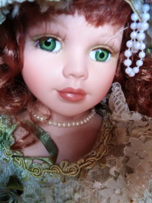 Porcelain doll with green eyes like new