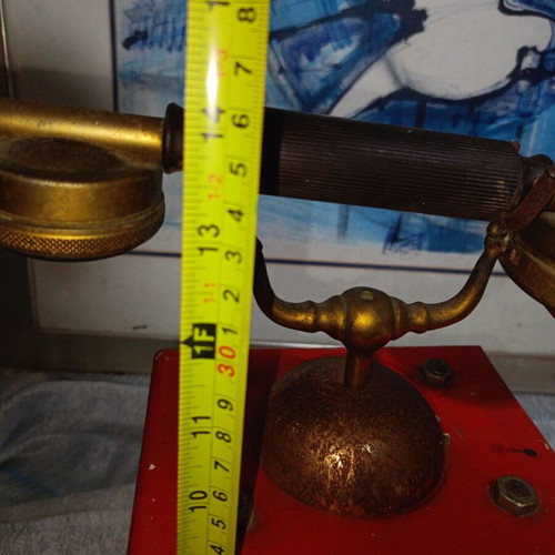 Vintage metal rotary phone, red with gold details