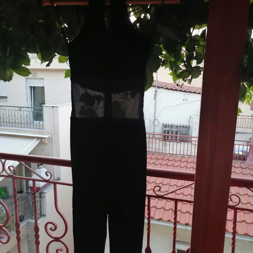 Black velvet jumpsuit with sheer mesh panel, halter neck