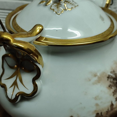 Antique porcelain teapot with wooden handle used