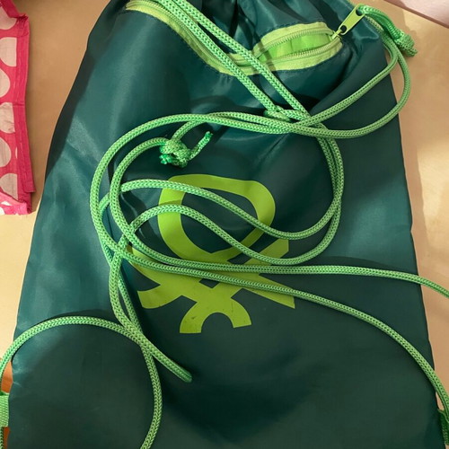 Benetton travel accessory set with pink shoulder bag and green drawstring backpack
