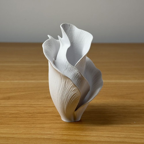 Decorative vase sculpture with ethereal flower design