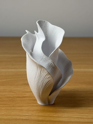 Decorative vase sculpture with ethereal flower design