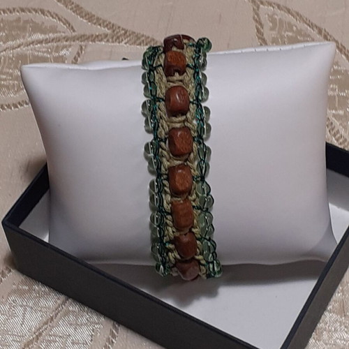 Handmade bracelet with brown wooden beads and light green glass