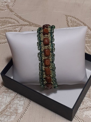 Handmade bracelet with brown wooden beads and light green glass