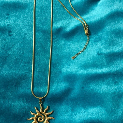 Gold necklace with sun pendant, new condition