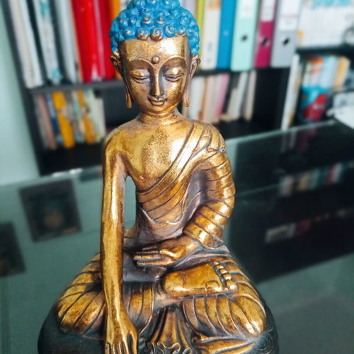 Golden ceramic Buddha statue sitting meditation decoration
