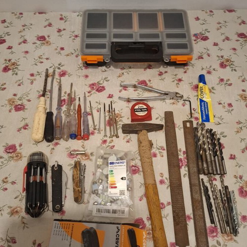 Tool set used, including screwdrivers, pliers, hammer, drills, multitools