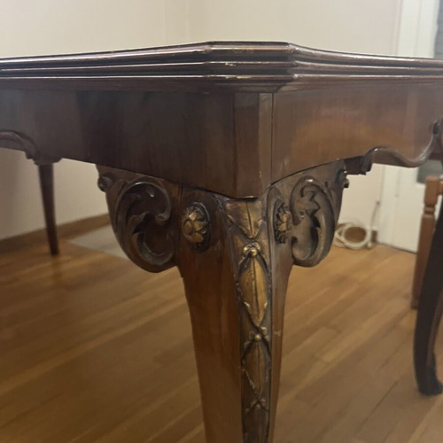 Wooden dining table used with carved legs and metal details