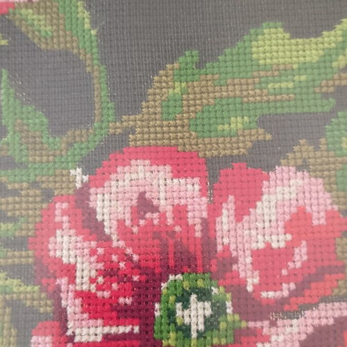 Vintage cross stitch picture of roses and poppies