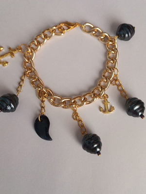 Gold bracelet with charms, new, dark blue details