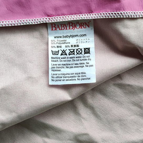 Babybjorn smock used for feeding or play pink fuchsia