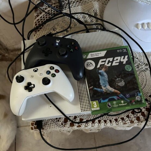 Xbox One S console with two controllers and FC24 game