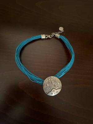 Vintage handmade necklace with metal pendant and embossed designs