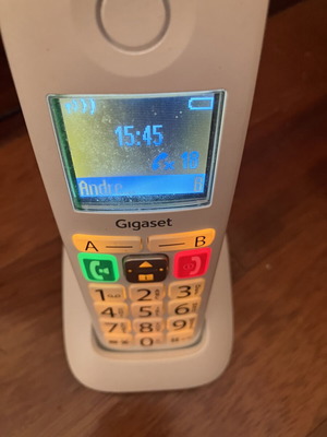 Cordless landline telephone with big numbers used, white