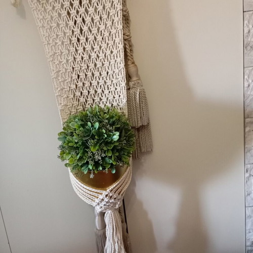 Two knitted wall hangers for pots, different sizes