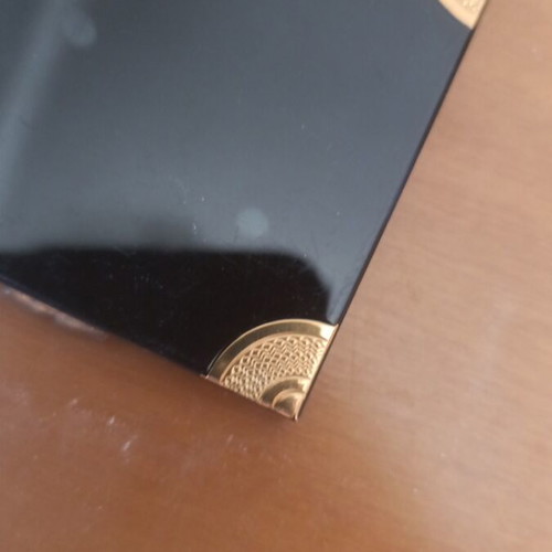 Compact powder with mirror used, black and gold design
