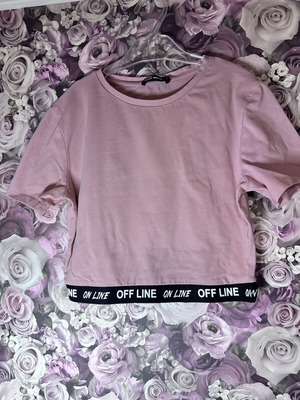 Pink short-sleeve crop top with black elastic band, size M