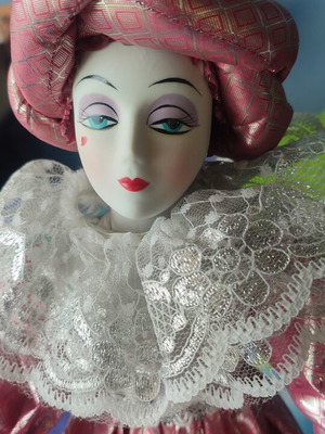 Porcelain doll in pink shiny outfit new