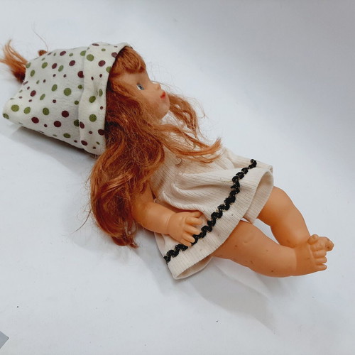 Vintage plastic doll 60s with open eyes, white knitted dress, tiara