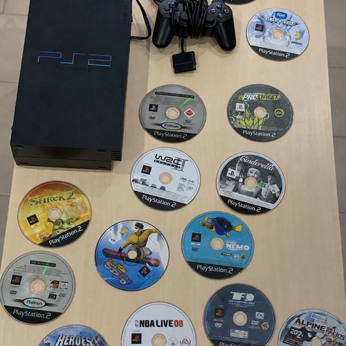 PlayStation 2 console with controller, multi tap and cables