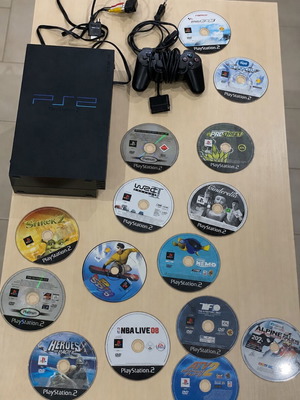 PlayStation 2 console with controller, multi tap and cables
