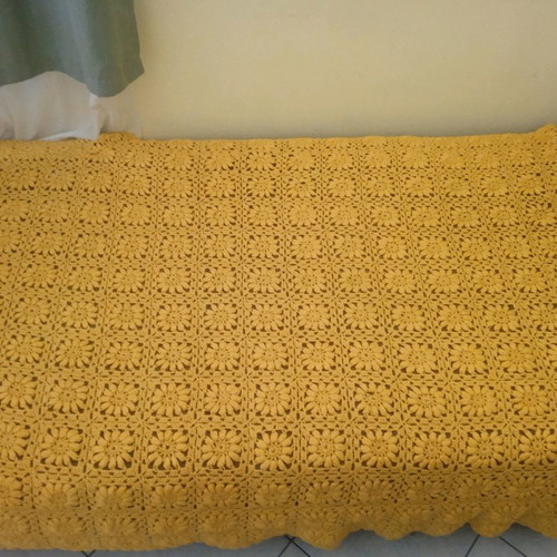 Knitted handmade blanket used with embossed daisies