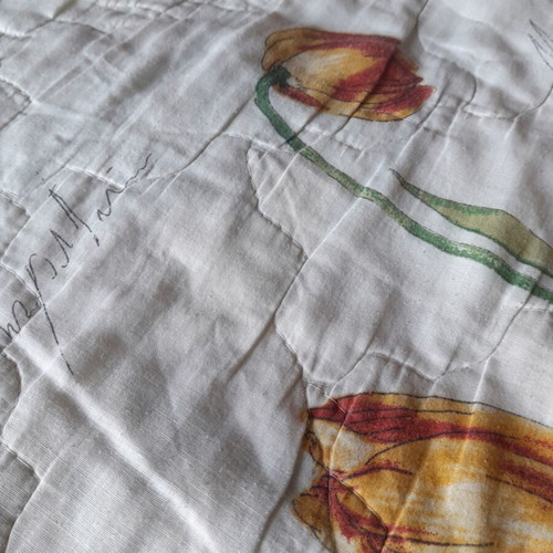 Single quilt used, white with floral patterns