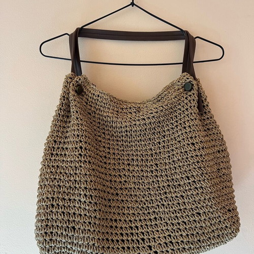 Woven boho style beach bag like new with brown leather handles and inner zip pocket