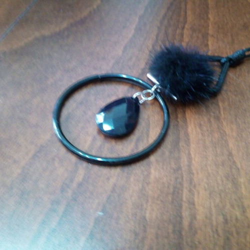 Black teardrop pendant with fur tassel on leather strap like new