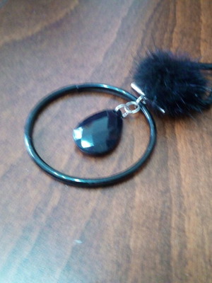 Black teardrop pendant with fur tassel on leather strap like new