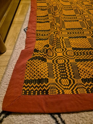Machine-made rug with embroidery red frame and orange interior like new