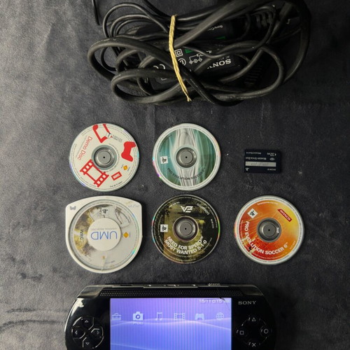 PlayStation Portable PSP-1000 used with charger, 5 games, and Memory Stick