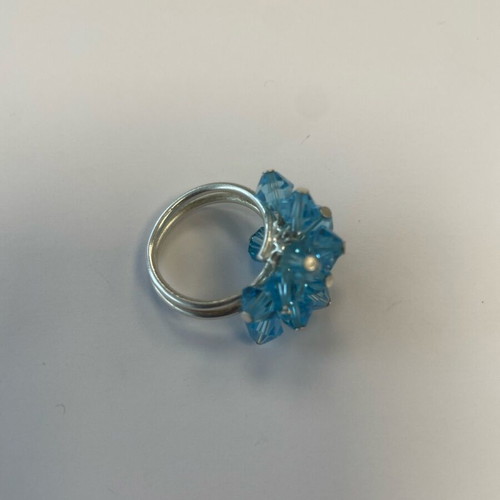 3D ring with bright blue moving crystals like new