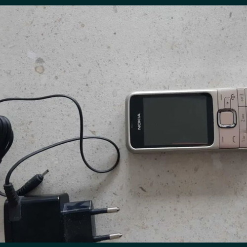 Nokia silver mobile phone with charger