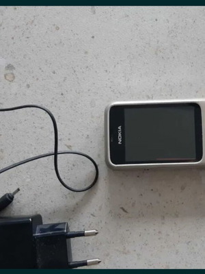 Nokia silver mobile phone with charger