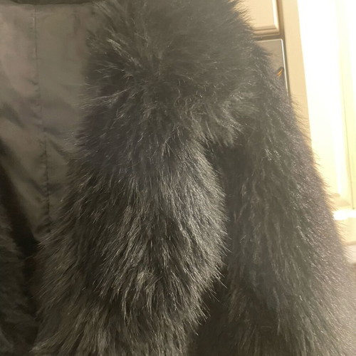 Long-haired fur used, black synthetic with pockets