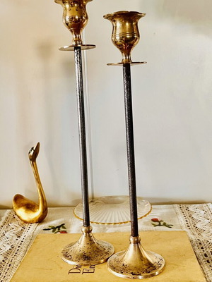 Vintage brass candlesticks with thin iron stems used