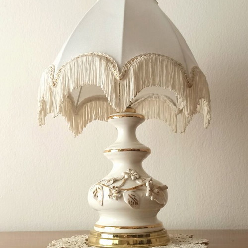Vintage porcelain table lamp with fabric white shade and fringes used