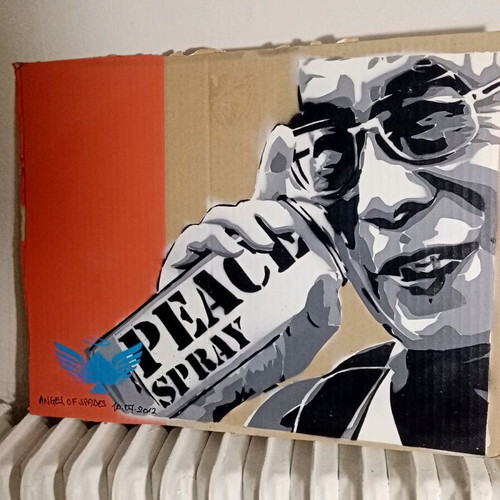 Spray the World with Peace stencil art used on cardboard