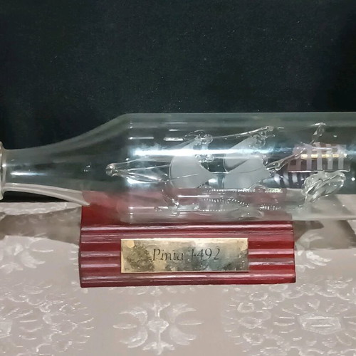 Glass ship in glass bottle like new with wooden base